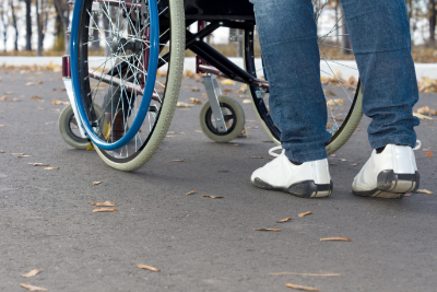 photo of nurse walking patient in wheelchair
