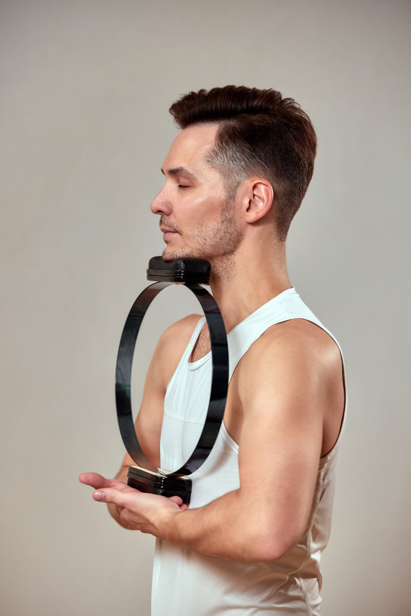 photo of man using neck flexor