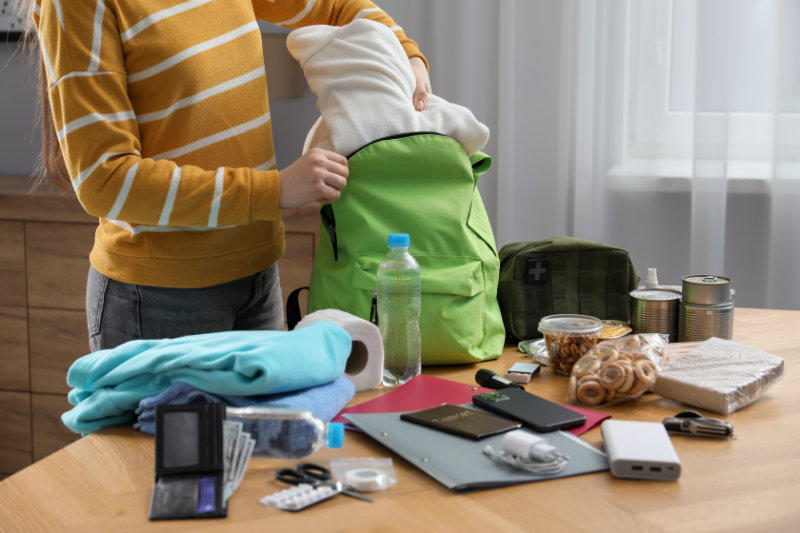 photo of woman packing disaster go bag