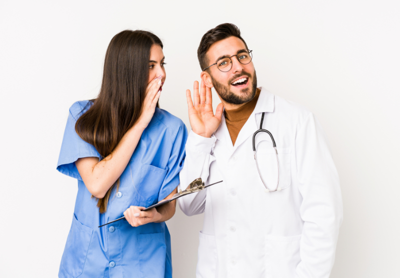 photo of a nurse gossiping with a co-worker