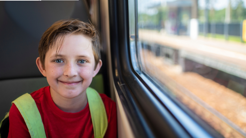 photo of boy on bus