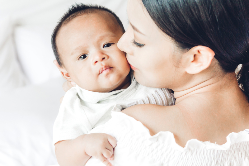 photo of woman holding baby