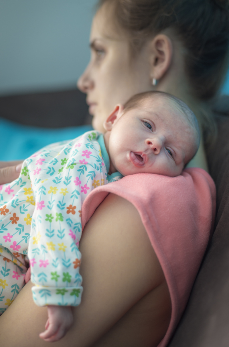 photo of woman holdling infant
