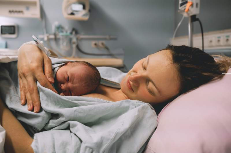 photo of mother holding baby skin to skin on chest