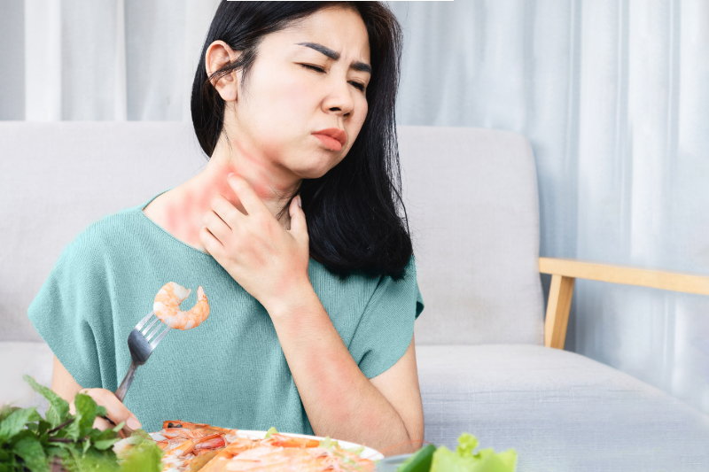woman having allergic reaction to seafood