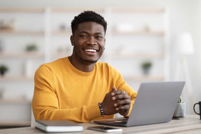 photo of man sitting with laptop