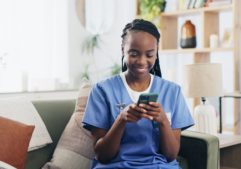 Photo of nurse on her cell phone smiling