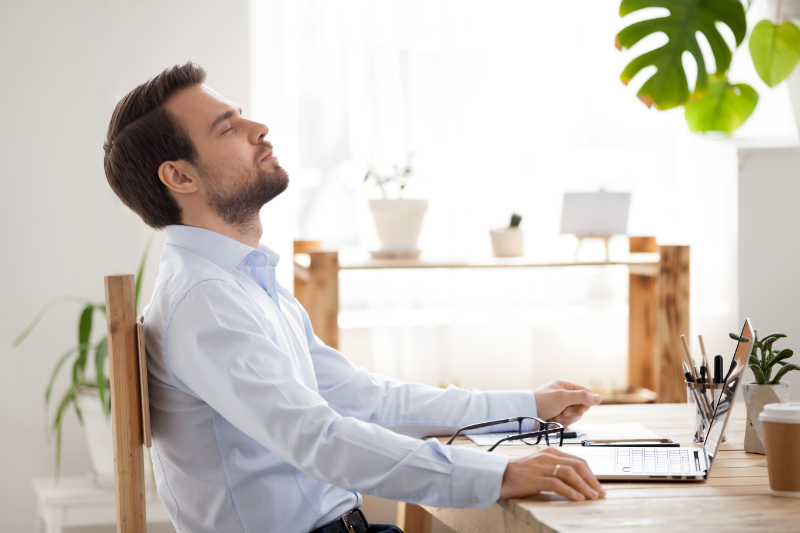 photo of man taking a mindful moment at laptop