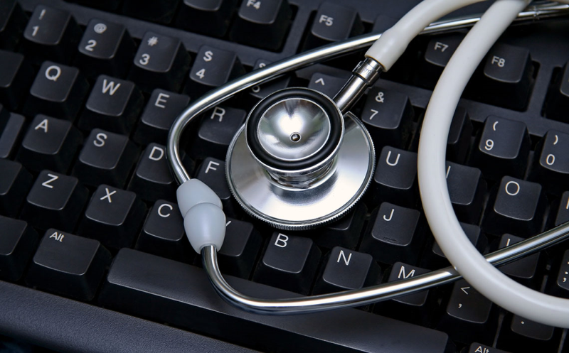 Photo of stethoscope on top of a black keyboard