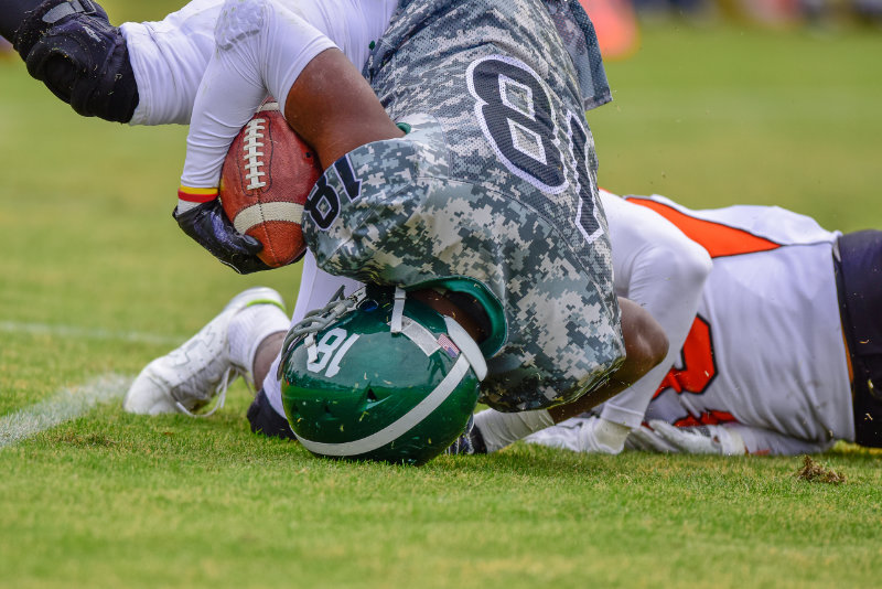 photo of football player landing on head