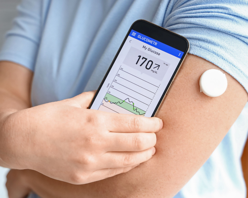 photo of individual using remote glucose monitoring device