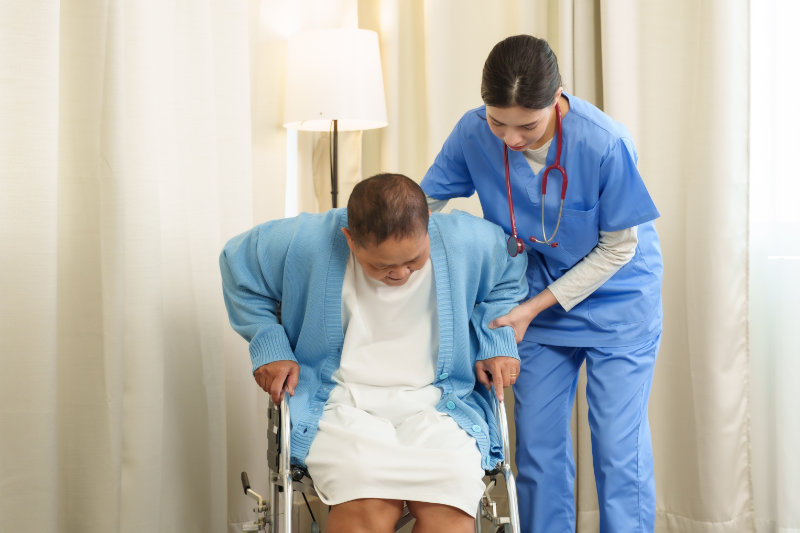 photo of woman safely using wheelchair with assistance