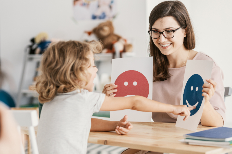 photo of woman using visual supports with child